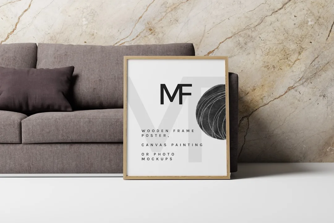 a picture frame sitting on the floor next to a couch